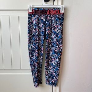 Under Armour leggings with a black , blue and , peach, comes in a girls large